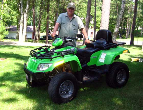 Curt Asche and his 2007 Arctic Cat TRV ATV with 50,000 miles.