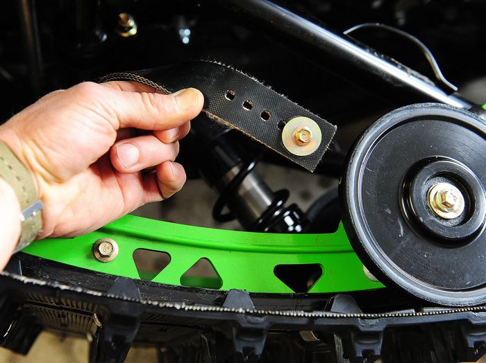 Adjusting the front arm limiter straps on an Arctic Cat rear suspension