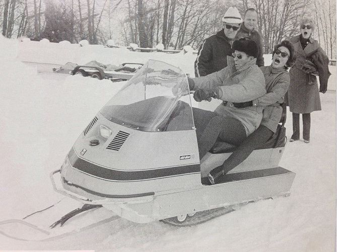 Ronald & Nancy Reagan hit the gas on a snowmobile.