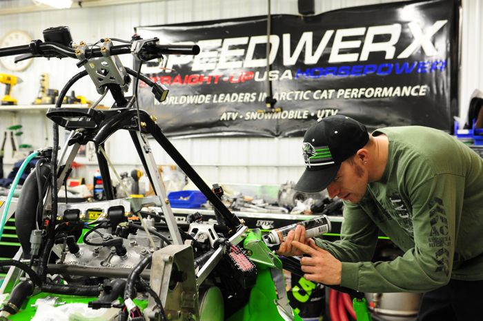 Wes Selby works on a 2015 Arctic Cat Soo sled in the Race Shop. Photo by ArcticInsider.com