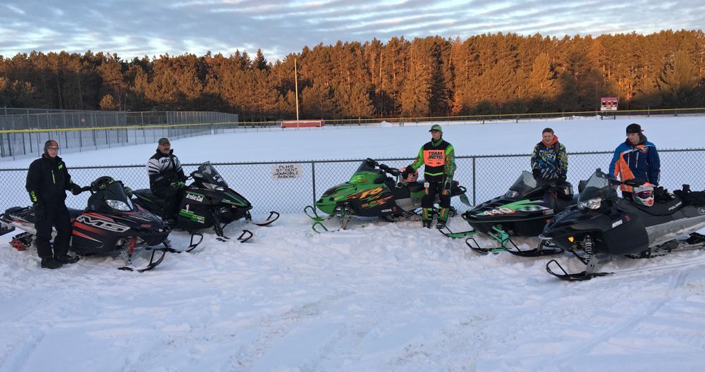 Students at Pequot Lakes, MN, High School ride snowmobiles to school. 