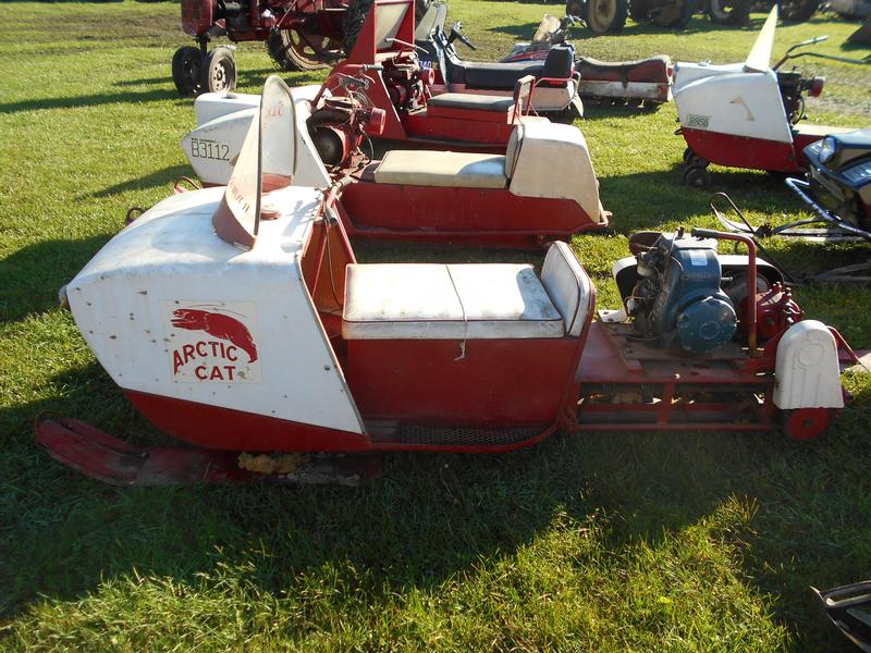 Vintage sled auction with Arctic Cat machines.