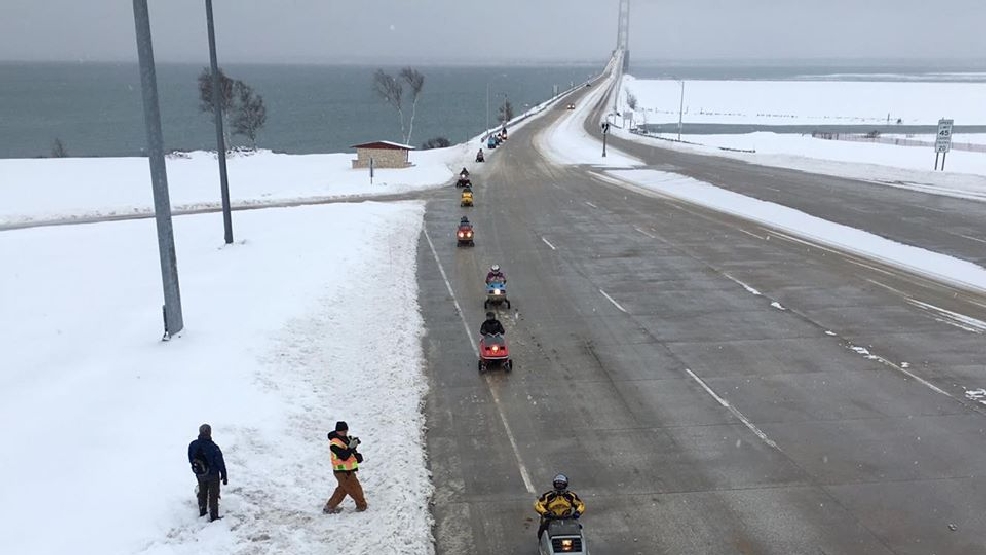 Snowmobiles crossing the mighty Mackinac bridge
