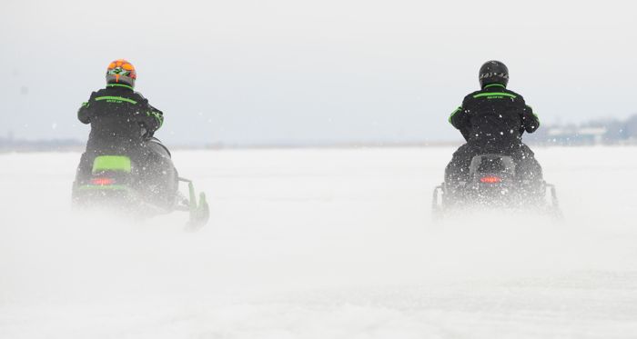 Arctic Cat engineers comparing snowmobile top-speed and acceleration.