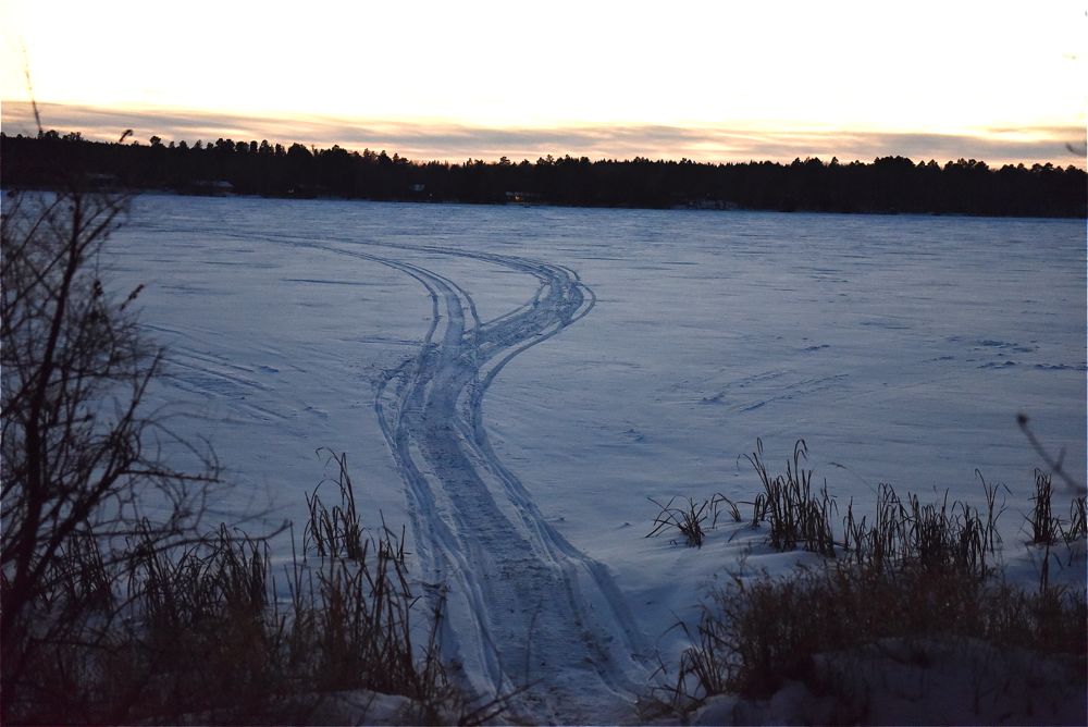 Snowmobile tracks in snow. ArcticInsider.com