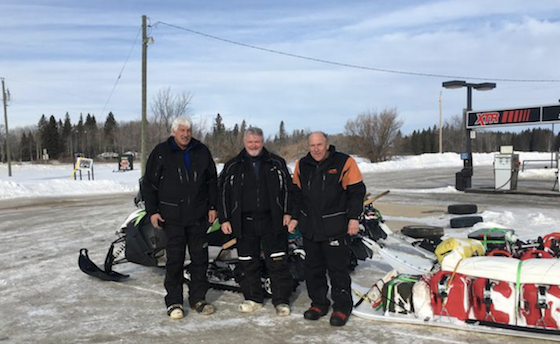 (L-R) Rex Hibbert, Rob Hallstrom and Paul Dick drew quite a following during the course of their epic snowmobile trip to Churchill, Man. Here, they stopped for a photo March 12 during a quick stop in Ethelbert, Man., north of Riding Mountain National Park. (Photo courtesy of Rob Hallstrom)