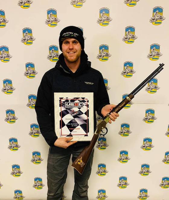 #312 Zach Herfindahl is Back-to-Back GG500 Champion posing with his custom USXC Henry Rifle