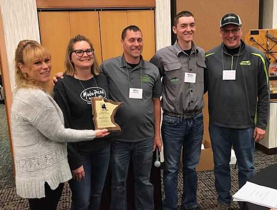 MotoProz owners, Mike and Missy Papenfus are presented MnUSA's Dealer of the Year Award along with Arctic Cat Sales Rep, Tom Schaefer (Far Right)