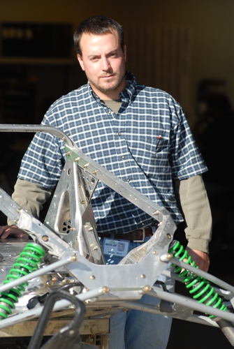 Brian, shown here with a Twin Spar chassis outside of the Engineering shop